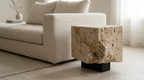 Modern living room with a textured stone side table and beige sofa.