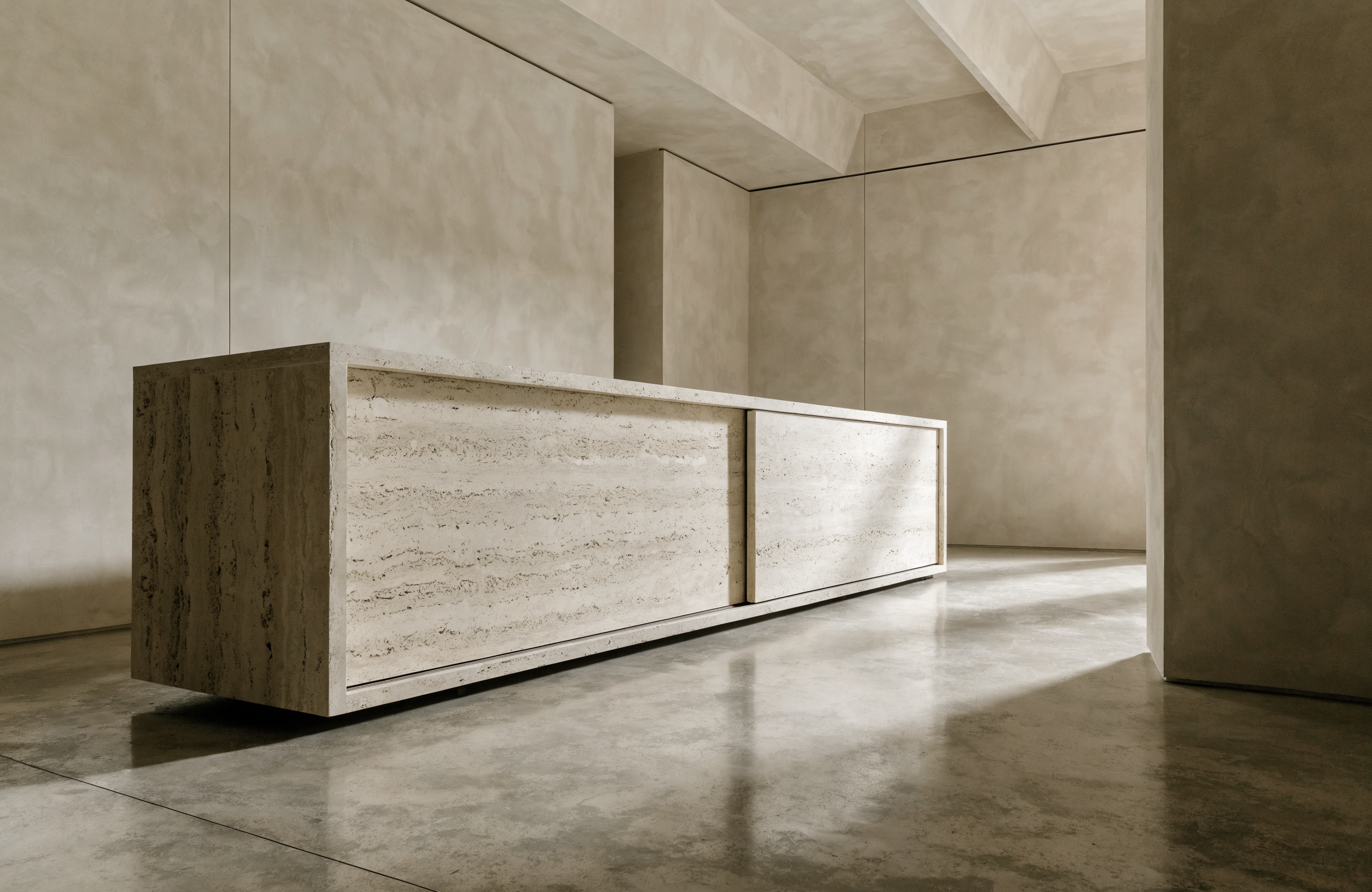 The Travertine Credenza in minimalist interior — polished concrete floor, plaster walls