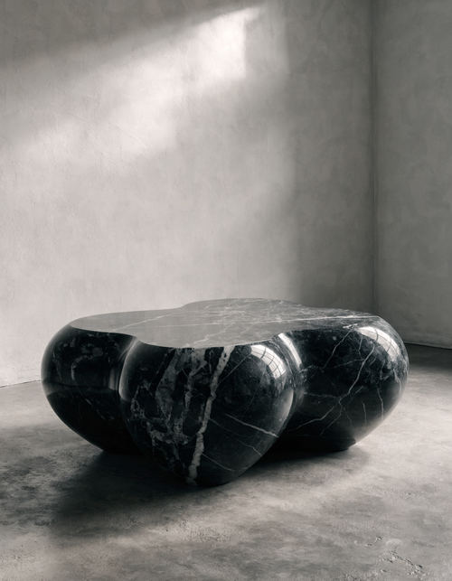 The Cloud Coffee Table in minimal interior — polished plaster walls, concrete floor, dark marble form
