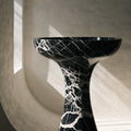 The Monolith Basin in Nero Marquina black marble — trumpet-form pedestal, dense white vein networks