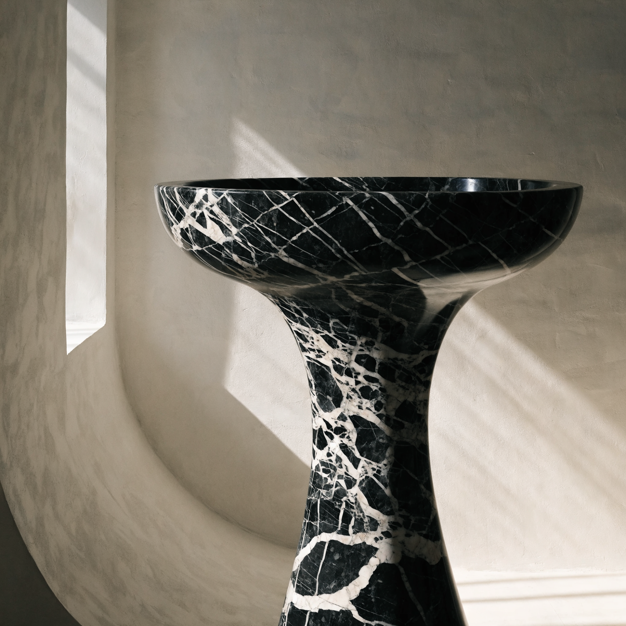 The Monolith Basin in Nero Marquina black marble — trumpet-form pedestal, dense white vein networks