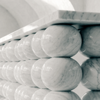 The Stacked Sphere Console in white Bianco Carrara marble — carved sphere-form legs, architectural sculptural form