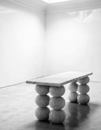 The Stacked Sphere Console in spare white interior — polished plaster walls, monochrome editorial