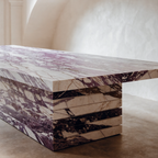 The Viola Dining Table in Italian Calacatta Viola marble — dramatic purple and burgundy veining, stacked slab base