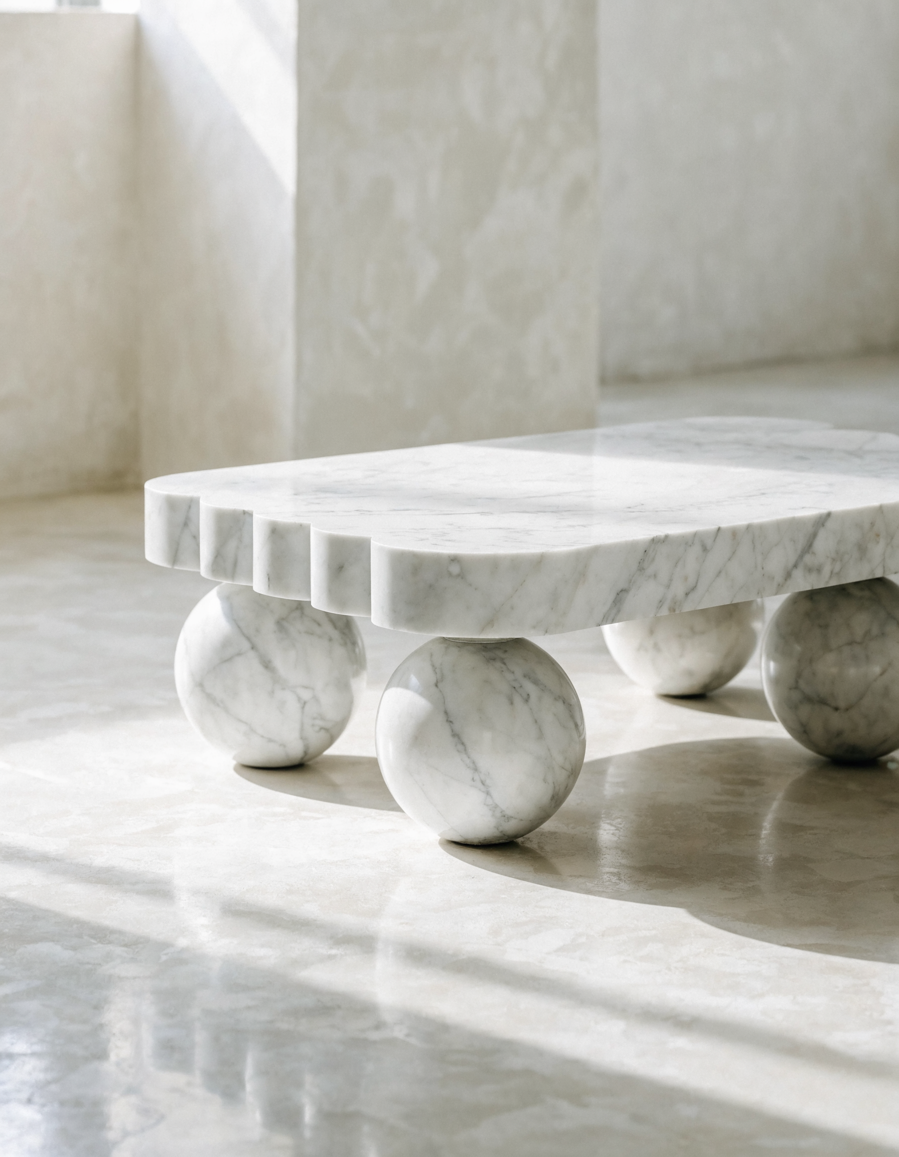 The Scalloped Coffee Table in bright minimal interior — polished plaster walls, scalloped edge detail