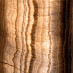 Translucent onyx detail — warm amber and honey tones, internal mineral banding, geological close-up
