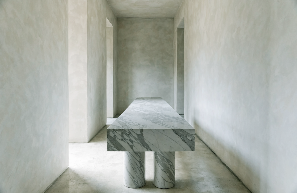 The Roman Colonnade Console in minimalist hallway — polished plaster walls, grey veined marble, Architectural Digest