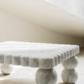 The Scalloped Coffee Table in Bianco Carrara marble — carved scalloped perimeter edge, sphere legs